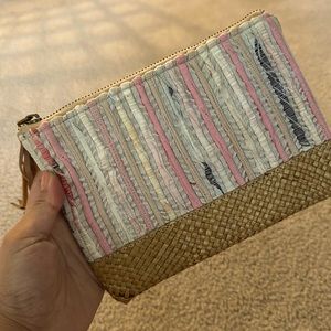 Handcrafted clutch with woven fabric, straw bottom, leather tassel